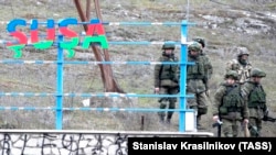 Azerbaijani soldiers patrol at a checkpoint on a road outside the town of Susa (Shushi in Armenian) on November 26.