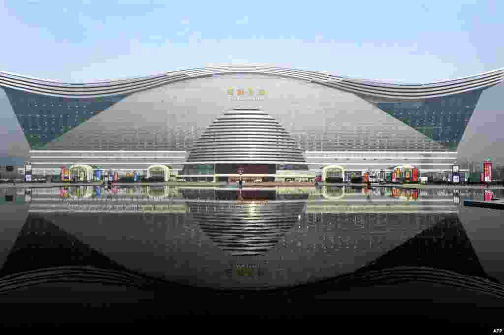 The New Century Global Center is reflected in an artificial lake. The center appears to be another symbol of China&#39;s economic might. 