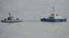 Ukrainian ships are seen being towed out of Kerch on November 17.