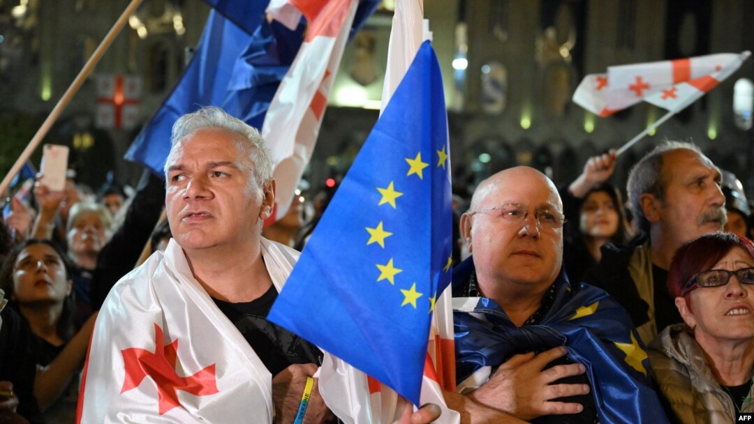 Manifestanți din Tbilisi, purtând steagurile Georgiei și Uniunii Europene, protestează fașă de adoptarea în Parlament a legii „agenților străini”. 
