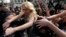Ukrainian activist Inna Shevchenko (center) and other members of the women's rights group Femen struggle with police officers during a protest in Paris in April 2013.