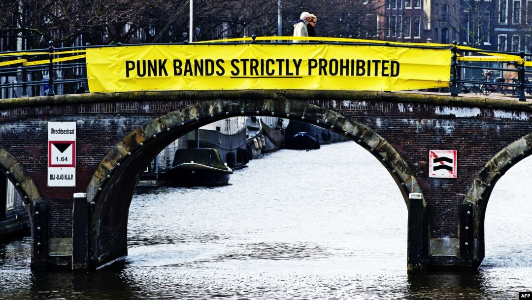 A banner on a bridge in Amsterdam mocks Russian President Vladimir Putin ahead of an April visit with a Pussy Riot allusion.