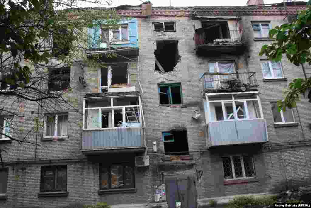 An apartment building damaged by shelling. 