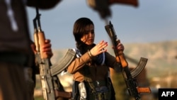 Iranian Kurdish fighters from the Kurdistan Democratic Party of Iran train as they prepare to celebrate Norouz, the Persian New Year, in the town of Koya, 100 kilometers north of Irbil in Iraq's Kurdish region, in March.