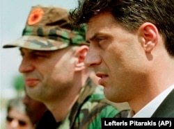 Kosovo Liberation Army leader Hashim Thaci (right) attends a memorial ceremony for ethnic Albanian leader Fehmi Agani in Pristina on August 6, 1999.