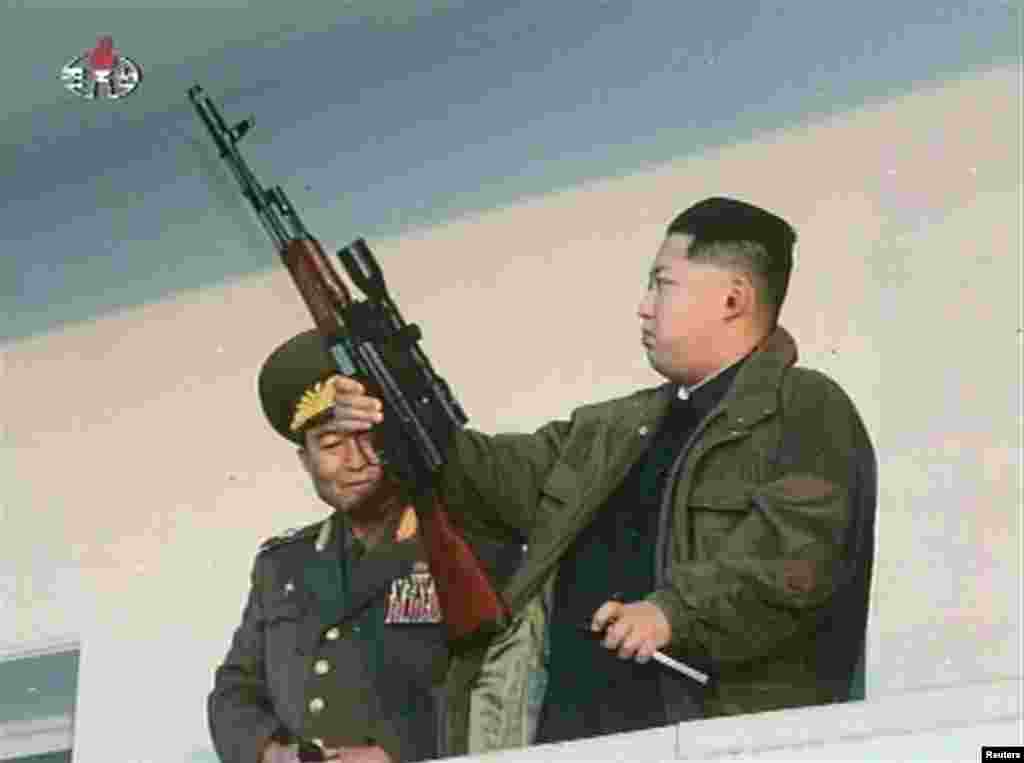 North Korean leader Kim Jong Un brandishes a weapon in January 2012, shortly after taking control of the communist dictatorship.