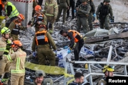Israeli emergency personnel work at the site of an Iranian strike in the town of Beit Shemesh on March 1.