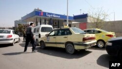 Syrians queue to fill their cars with gasoline at a station in the capital Damascus on April 8, 2019. 