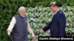 FILE: Indian Prime Minister Narendra Modi (L) and Chinese President Xi Jinping
