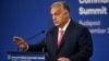 Hungarian Prime Minister Viktor Orban gestures at a press conference ahead of a European summit in Budapest. 