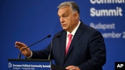 Hungarian Prime Minister Viktor Orban gestures at a press conference ahead of a European summit in Budapest. 