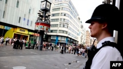 A police officer stands by a cordoned-off area on London's Leicester Square on August 12.