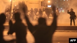 Egyptian protesters gesture as they clash with riot police on Cairo's landmark Tahrir Square in November 2011, nine months after demonstrations sparked longtime ruler Hosni Mubarak's ouster.