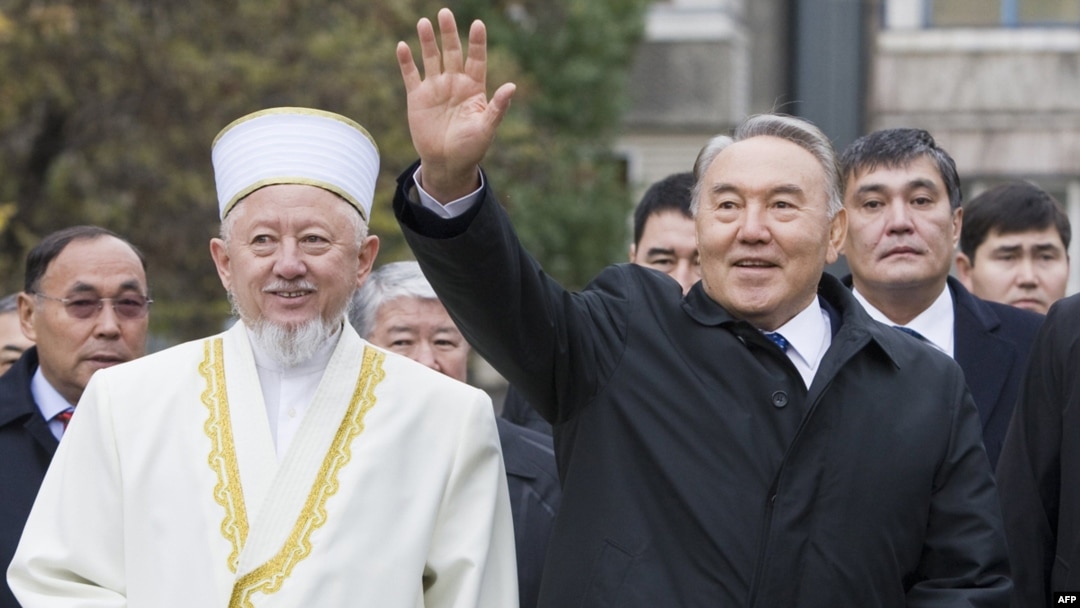 Kazakh President Nursultan Nazarbaev waves next to Absattar Derbisali, the supreme mufti of Kazakhstan, as he visits the Central Mosque in Almaty in November 2010.