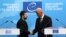 Ukrainian President Volodymyr Zelenskyy and Council of Europe Secretary-General Alain Berset shake hands after the signing of an agreement for establishing a special tribunal to try top officials responsible for Russia's invasion of Ukraine. 
