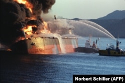 An oil tanker burns in December 1987 after being attacked by an Iranian warship as it neared the Strait of Hormuz.