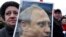 Woman holds portrait of Putin during demonstration in St. Petersburg in March
