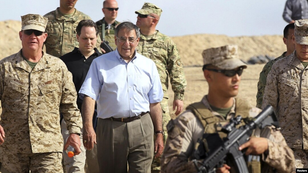 U.S. Secretary of Defense Leon Panetta (center) leaves a meeting with ISAF troops during his Afghanistan visit on March 14.