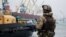 A Ukrainian serviceman stands guard in the Ukrainian port city of Mariupol on the Sea of Azov (file photo)