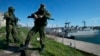 Russian soldiers guard a pier where two Ukrainian naval vessels are moored in Sevastopol, on the Crimean Peninsula, on March 5, 2014.