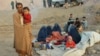 An Afghan family waits for help from the government and aid organizations in the northern Takhar province after fleeing their homes in neighboring Kunduz province in October.