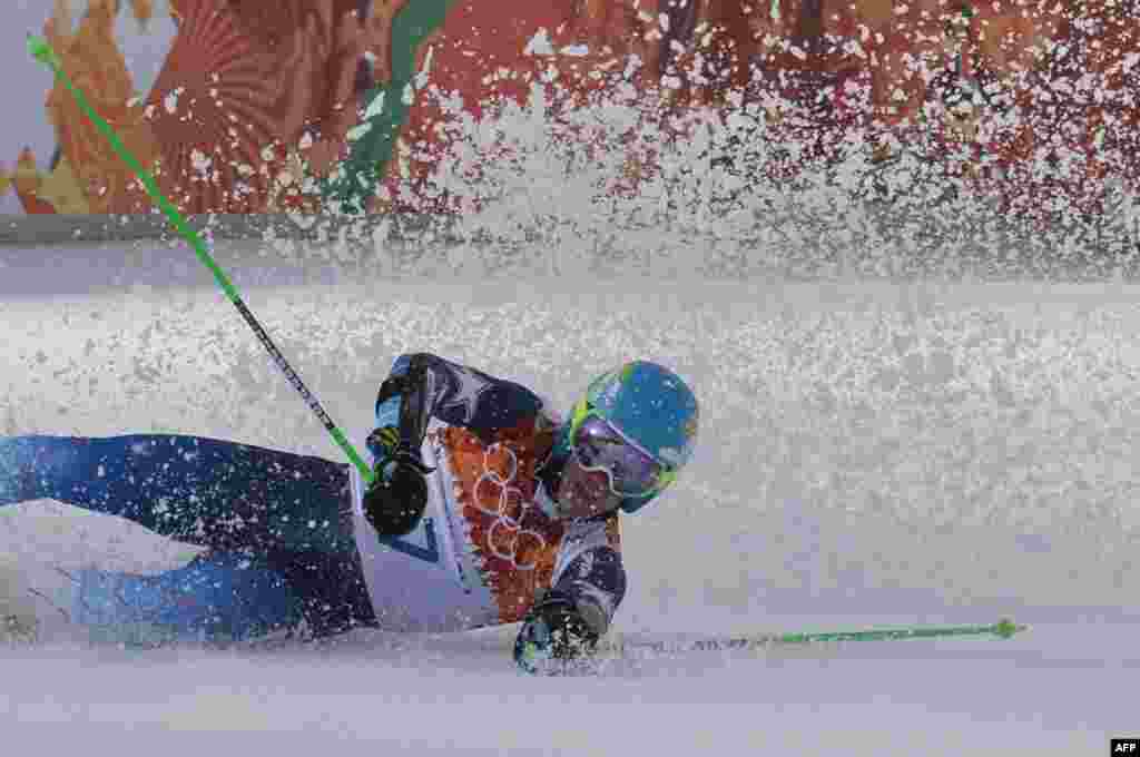 In the same competition, U.S. skier Ted Ligety falls in the finish area after taking gold. He also won a skiing gold at the 2006 Olympics. (AFP/Dimitar Dilkoff)