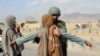 Afghan police check people on a highway as security has been beefed up following coordinated militants attacks on in Kandahar on November 14.