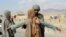 Afghan police check people on a highway as security has been beefed up following coordinated militants attacks on in Kandahar on November 14.