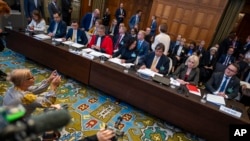 Ukraine's representative Anton Korynevych (right), Oksana Zolotaryova of the Ukrainian Foreign Affairs (second right), and other members of the Ukrainian delegation wait to addresses the judges at The Hague on September 19.