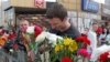 BELARUS -- A man places flowers near the site where a protester died on August 10 during a rally following the presidential election in Minsk, August 11, 2020