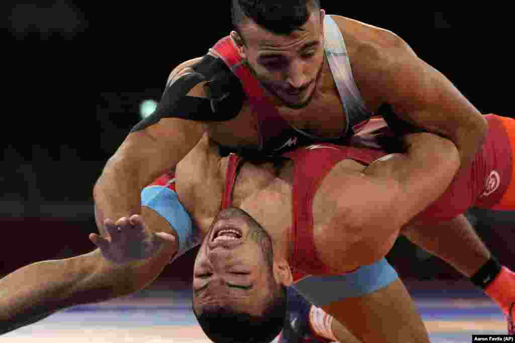 Ukraine's Parviz Nasibov, bottom, and Egypt's Mohamed Ibrahim Elsayed compete during the men's 67kg Greco-Roman wrestling semifinal match at the 2020 Summer Olympics, Tuesday, Aug. 3, 2021, in Chiba, Japan.