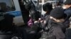 Поліцейські затримують жінку під час мітингу в Алмати, 28 лютого 2021 року