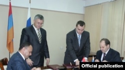 Armenia -- Defense Minister Seyran Ohanian (L) and Konstantin Biryulin, deputy head of Russia’s Federal Service for Military-Technical Cooperation, sign an agreement on arms sales to thrid countries on December 17, 2009.