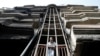 An Afghan man looks out from a damaged building after the July 28 attack in Kabul.