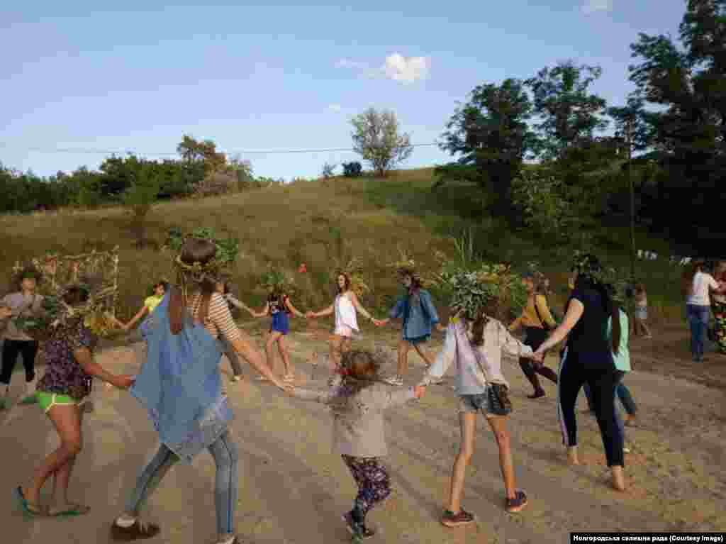 Young locals dance during an Ivan Kupala festival in Novhorodske. &nbsp; The Facebook page keeps locals up to speed on pothole repairs, public celebrations, and the minutiae of municipal spending. &nbsp;