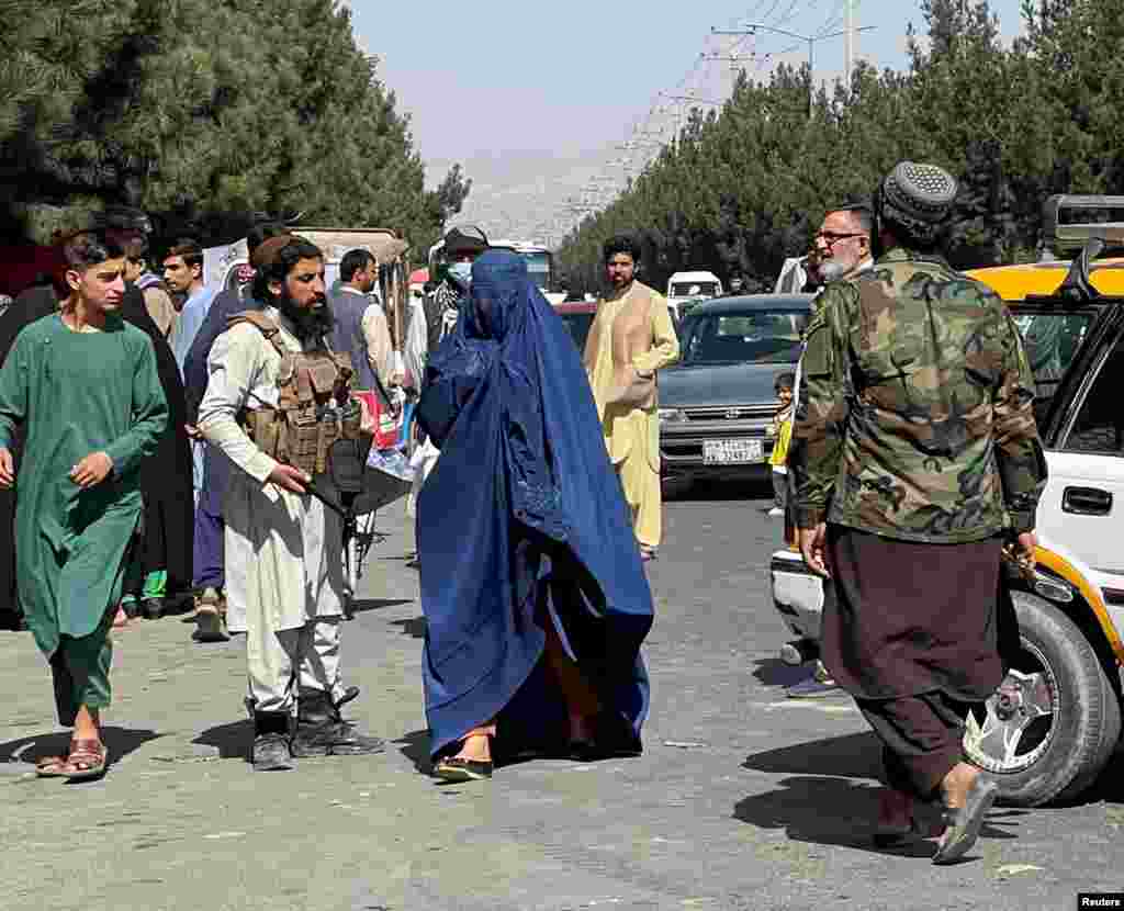 A woman covered by a burqa on the street in Kabul on August 27. &nbsp; A female Kabul resident who spoke to RFE/RL by encrypted messaging said there was uncertainty in the Afghan capital about what Taliban rule will be like. &quot;The spokesperson of the Taliban says they have changed and blah blah blah,&quot; the woman wrote. &quot;But ordinary Taliban on the streets are so much different and rude, carrying guns.&quot; &nbsp;