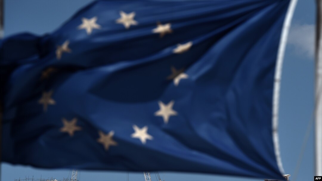 Greece -- An EU flag waves above the ancient temple of Parthenon atop the Acropolis hill in Athens, July 7, 2015