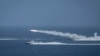 Iranian military fires a missile targeting a mock-up of U.S. aircraft carrier in the strategic Strait of Hormuz, July 28, 2020