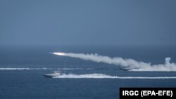 Iranian military fires a missile targeting a mock-up of U.S. aircraft carrier in the strategic Strait of Hormuz, July 28, 2020