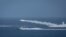 Iranian military fires a missile targeting a mock-up of U.S. aircraft carrier in the strategic Strait of Hormuz, July 28, 2020