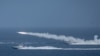 IRAN -- Iranian military fires a missile targeting a mock-up of U.S. aircraft carrier in the strategic Strait of Hormuz, July 28, 2020