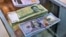 A pile of Iranian rials sits next to a stack of U.S. dollars. Iran's national currency hit a record low on February 11.