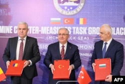 Turkish Defense Minister Yasar Guler (center), Romanian Defense Minister Angel Tilvar (left), and Bulgaria's Deputy Defense Minister Atanas Zapryanov pose after signing an agreement on demining the Black Sea amid Russia's war against Ukraine on January 11 in Istanbul.