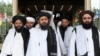 FILE: Taliban deputy leader Mullah Abdul Ghani Baradar (C) with members of the Taliban political office in Qatar.