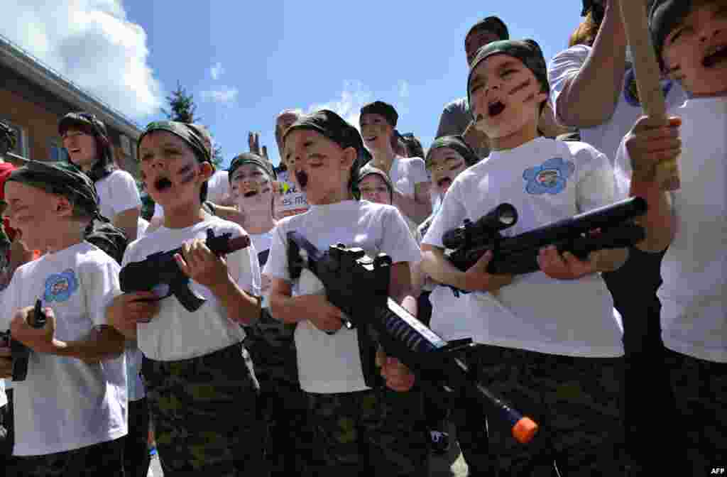 Children shout as they hold toy rifles during a patriotic military game called Zarnitsa in a kindergarten in Stavropol, Russia. (AFP/Danil Semyonov)