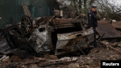 A Ukrainian police officer attends the site of a Russian military strike on a residential area in Pavlohrad on May 1. 