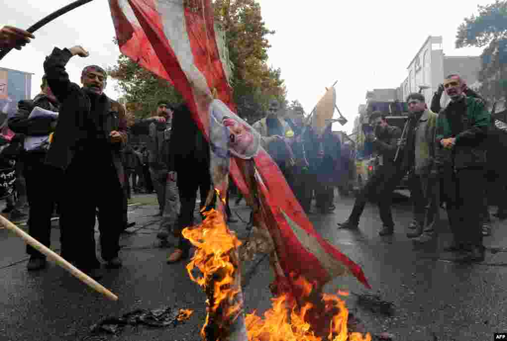 Iranians burn U.S. flags outside the former U.S. Embassy in Tehran on&nbsp;November 4, 2014. 