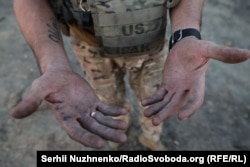 The hands of veteran Ukrainian sapper Andriy, also known as "Porthos"