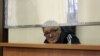 Bakhytzhan Kashkumbaev appears in court in Astana on January 22.