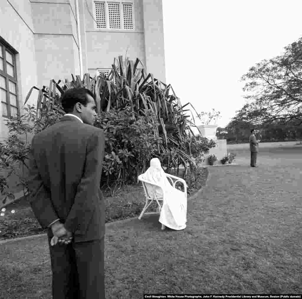 Allah Rakkhi, the wife of Bashir Ahmad, sits in a chair on the grounds of President Khan&rsquo;s residence in Karachi, where the camel ride took place.